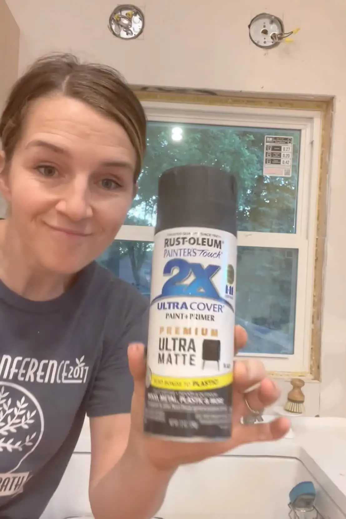 Painting windows black with spray paint.